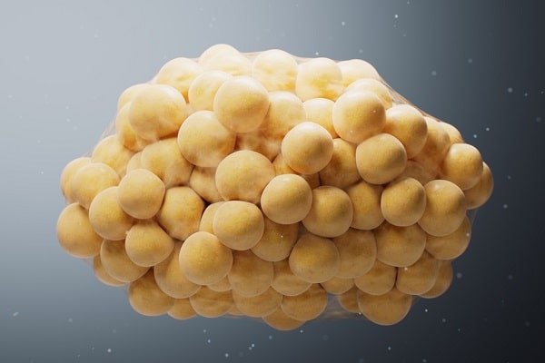 Dense cluster of small yellow spheres against a gray gradient background.