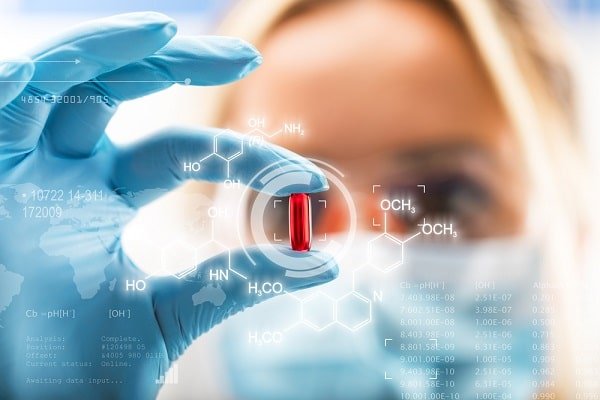 Scientist in blue gloves holds a red capsule, with molecular diagrams floating around the scene.