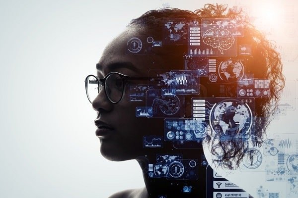 Profile of a woman wearing glasses with blue holographic data dashboards and world maps overlaid around her head, symbolizing AI analytics.